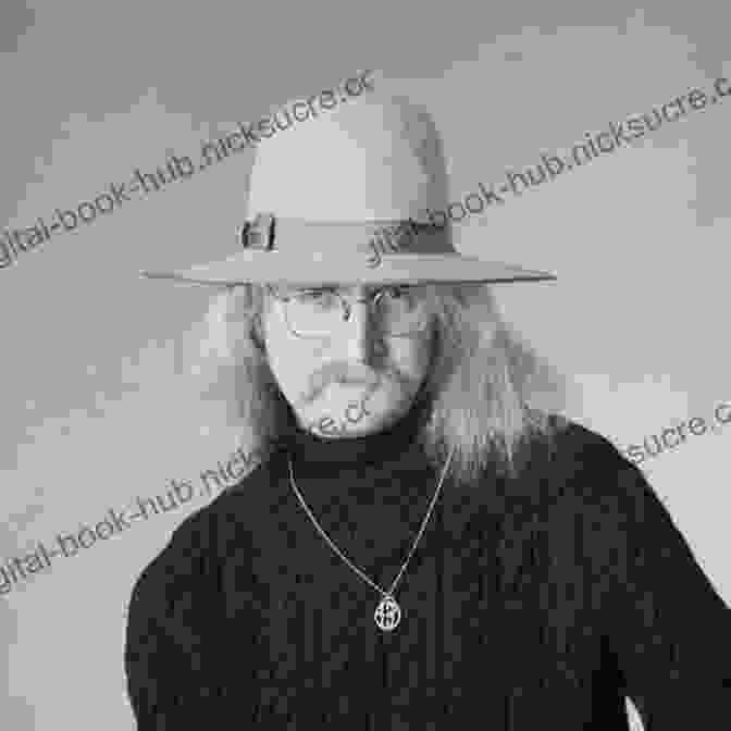 A Black And White Portrait Of Richard Brautigan, A Man With A Mustache And Long Hair, Sitting At A Desk With A Typewriter. Jubilee Hitchhiker: The Life And Times Of Richard Brautigan