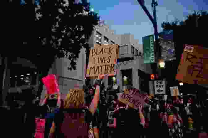 A Crowd Of People Holding Signs Protesting Inequality The Elephants In The Room: An Excavation ({bio}graphies 2)