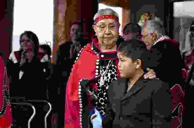 A Group Of Nisga'a Elders, Wearing Traditional Clothing, Sit Together On A Bench. Not My Fate: The Story Of A Nisga A Survivor