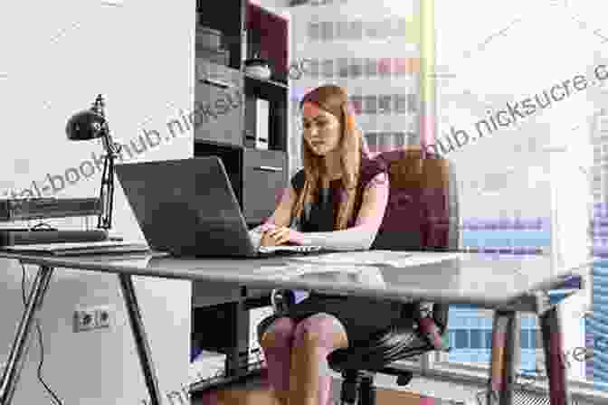 A Woman Sitting At Her Desk, Working On A Laptop With A Determined Expression. Daily Rituals: Women At Work