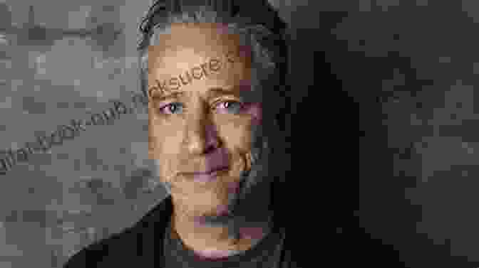 Jon Stewart Smiling And Holding A Microphone Angry Optimist: The Life And Times Of Jon Stewart